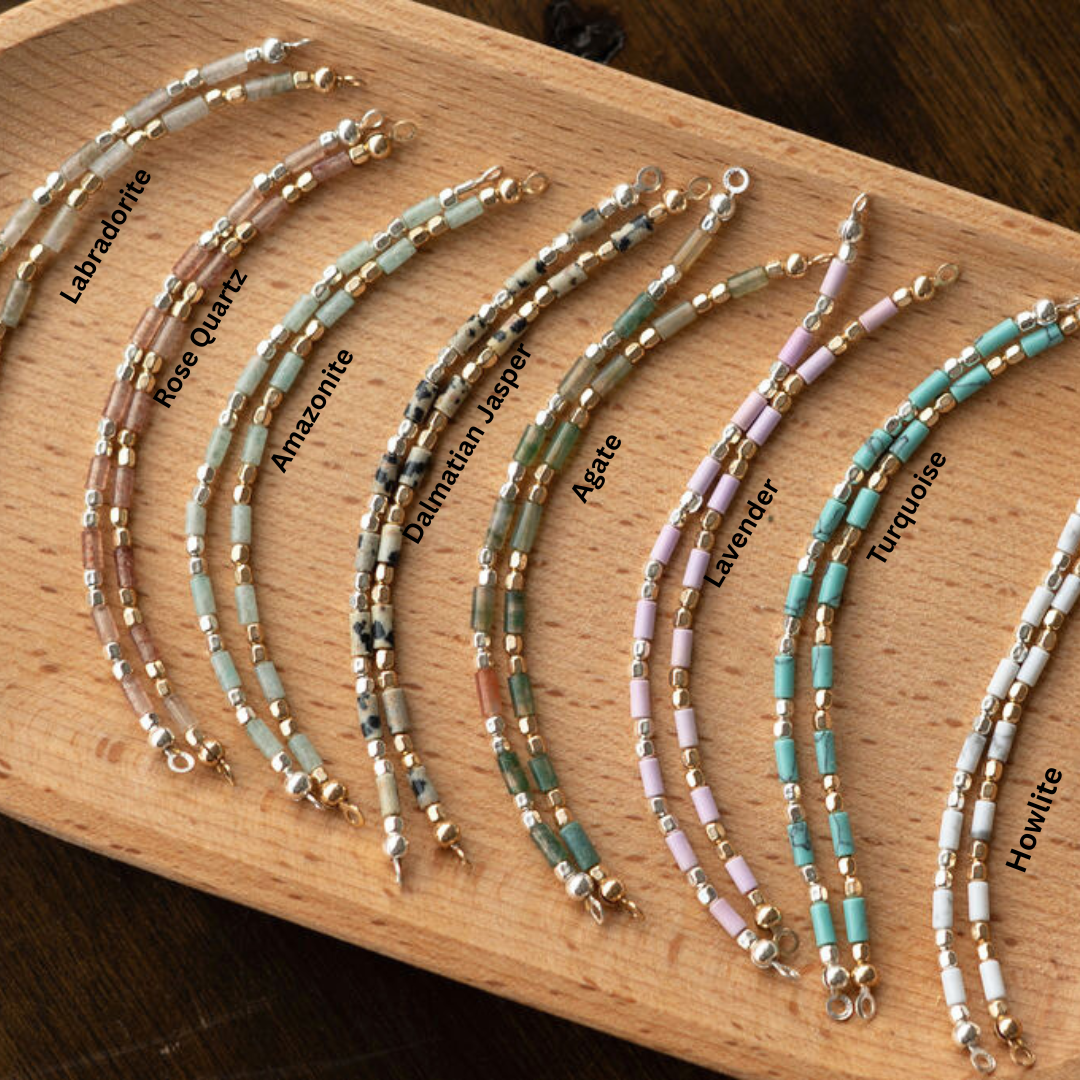 Set of half beaded bracelet on a wooden board with color labels