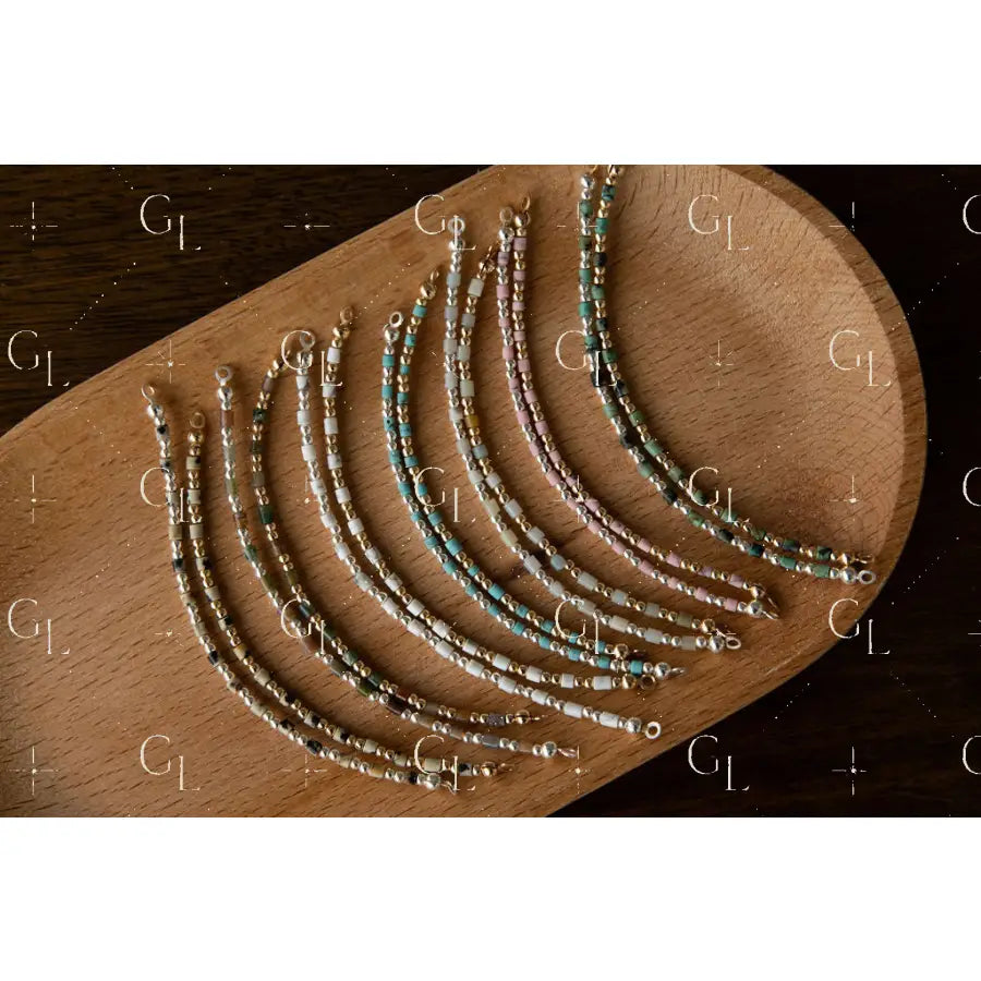 Set of beaded half bracelet on a wooden surface
