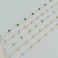 Three beaded necklaces on a light gray background