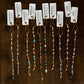 Set of beaded glow up with tags on a wooden surface