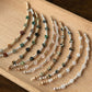 Set of beaded bracelets on a wooden tray