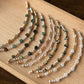 Set of beaded bracelets on a wooden tray