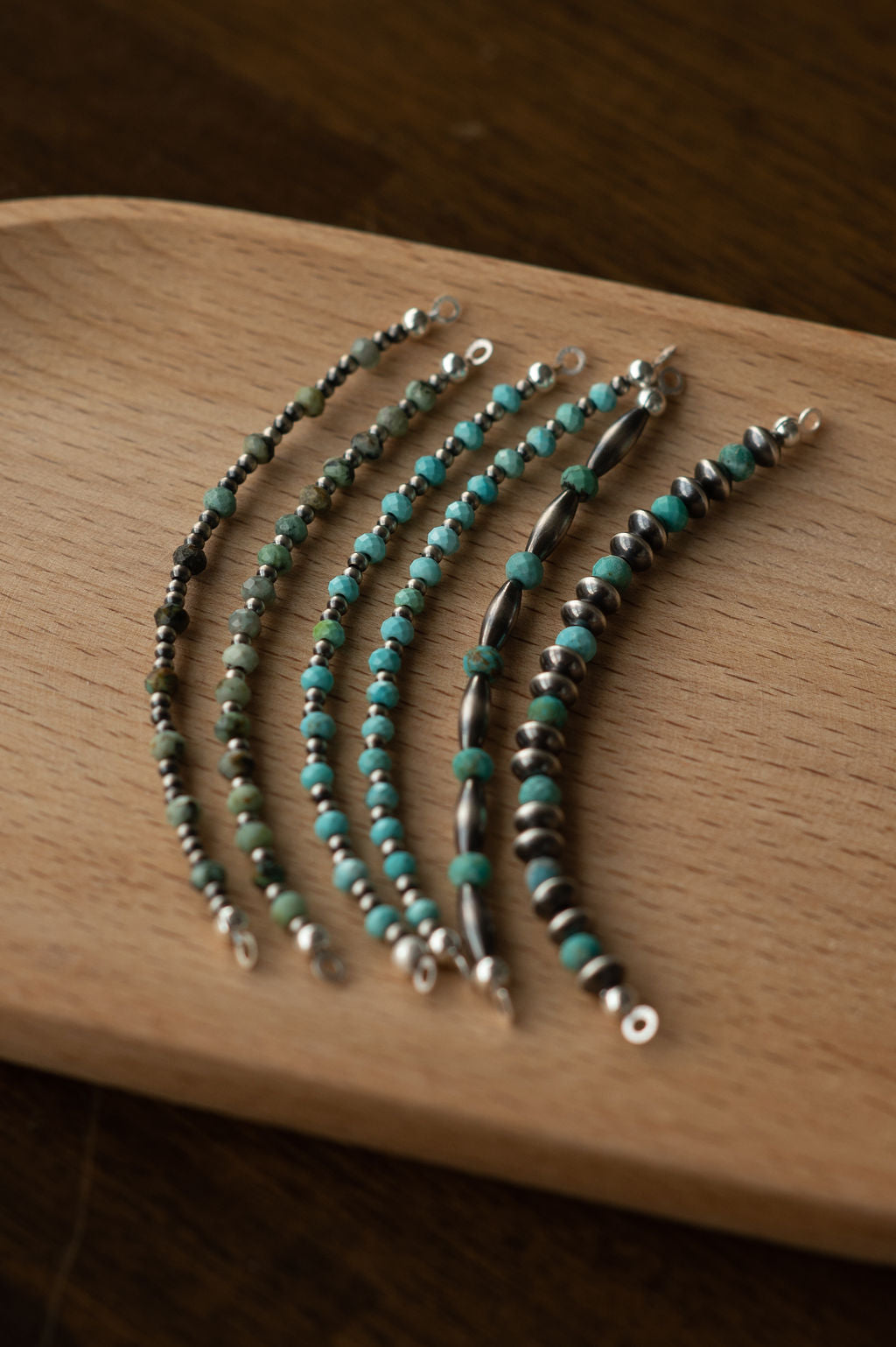 Navajo Pearl + Turquoise Glow Ups on wood surface 