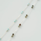 Necklace with small beads on a light gray background
