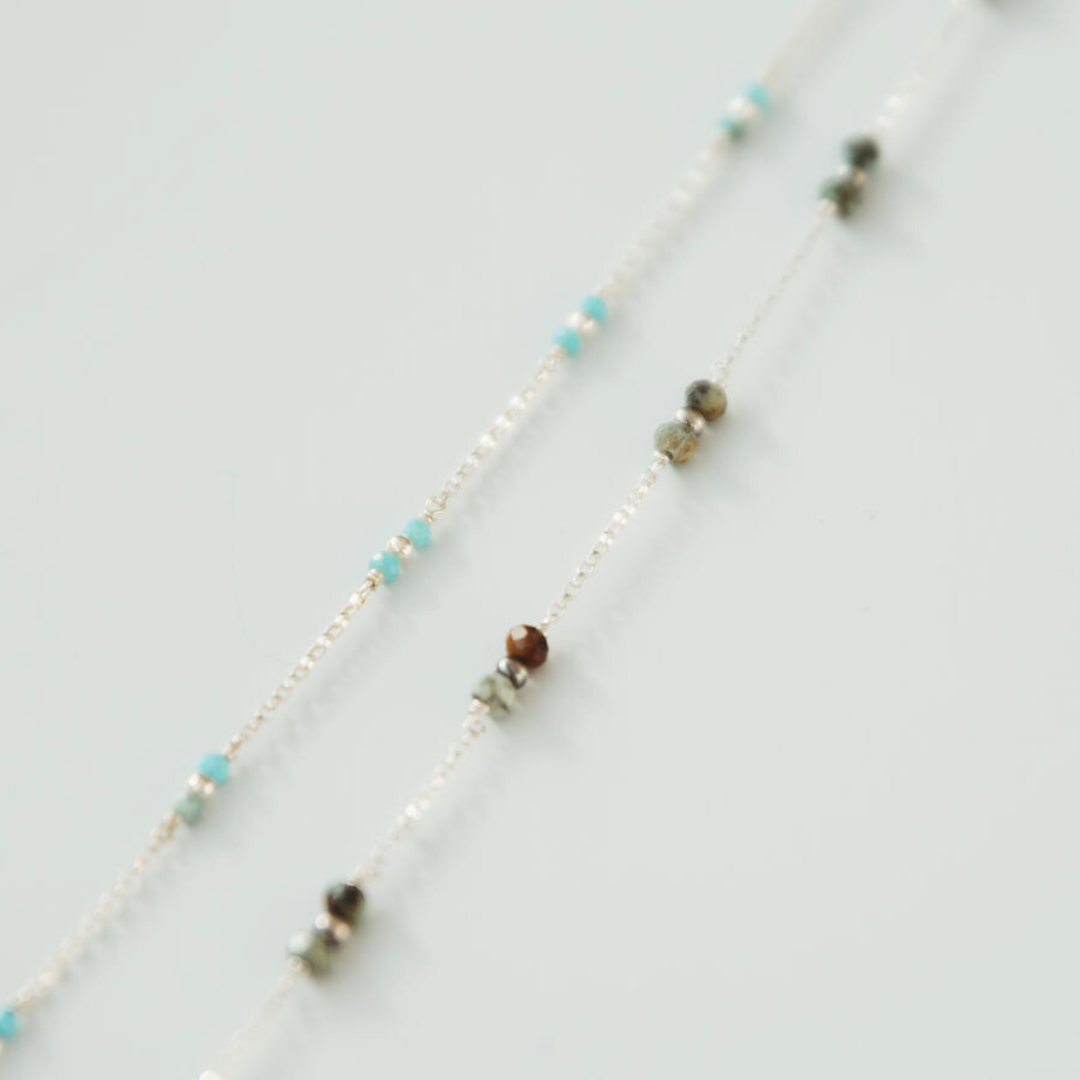 Necklace with small beads on a light gray background