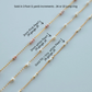 Gold beaded chains with different bead sizes and types on a light blue background