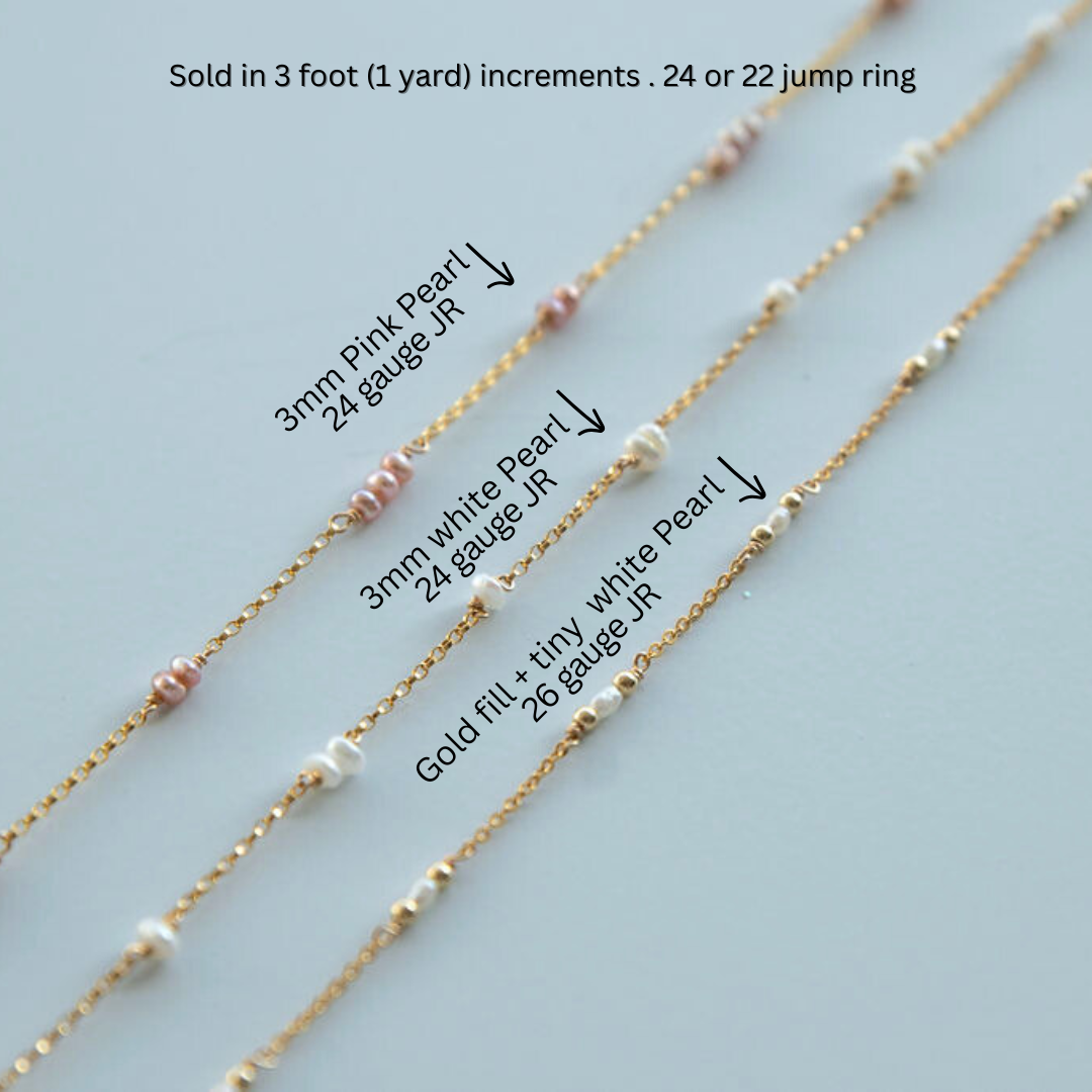 Gold beaded chains with different bead sizes and types on a light blue background