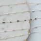 Delicate beaded necklace on a marble surface