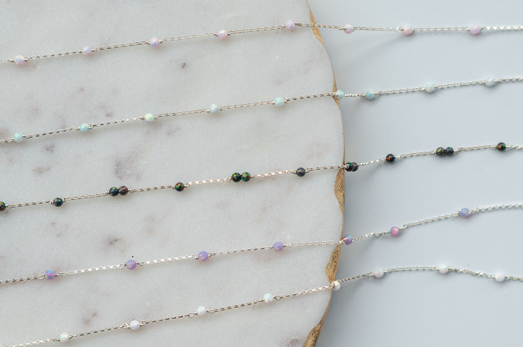 Delicate beaded necklace on a marble surface