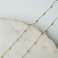 Delicate gold fill chain on a marble surface