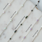gold fill sterling silver chain with colored opal beads on a marble surface