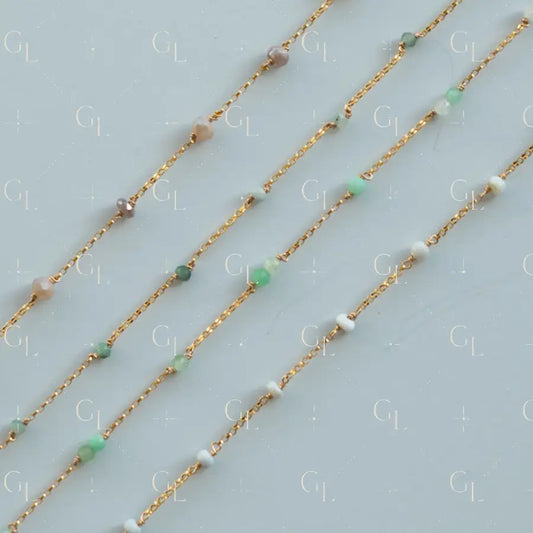 Gold chain necklaces with small beads on a light gray background