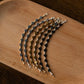 Set of chain saw chains on a wooden tray