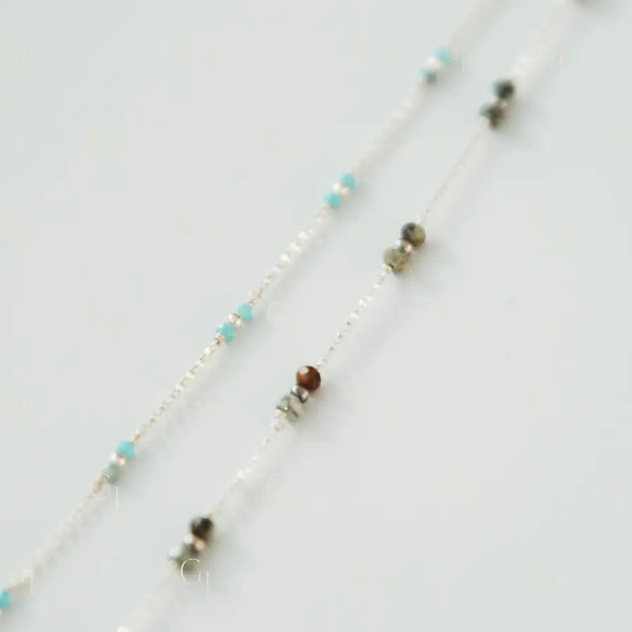 Necklace with small beads on a light gray background