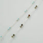 Necklace with multicolored beads on a light gray background