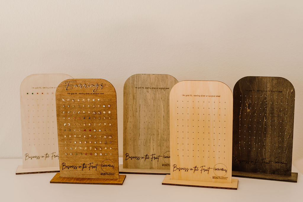 Set of wooden display stands with engraved text on a white background