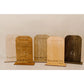 Set of wooden display stands with engraved text on a white background