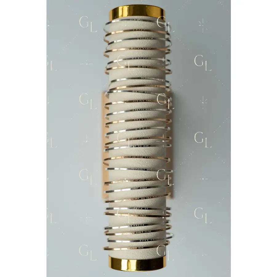 Decorative wall sconce with spiral design and gold accents on a gray background