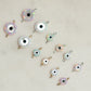 Evil eye charms on a light beige background