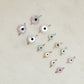 Evil eye charms on a light beige background