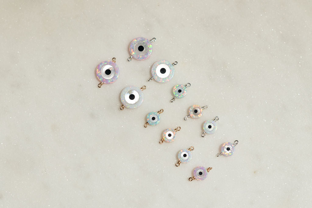 Evil eye charms on a light beige background