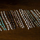 Set of beaded half bracelet on a wooden surface