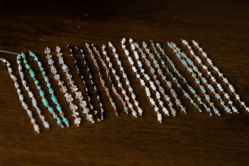 Set of beaded half bracelet on a wooden surface