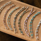 Set of beaded bracelets on a wooden tray