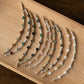Set of beaded bracelets on a wooden tray