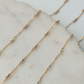 Gold chain necklace on a marble surface