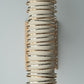 Decorative wall sconce with spiral design and gold accents on a gray background