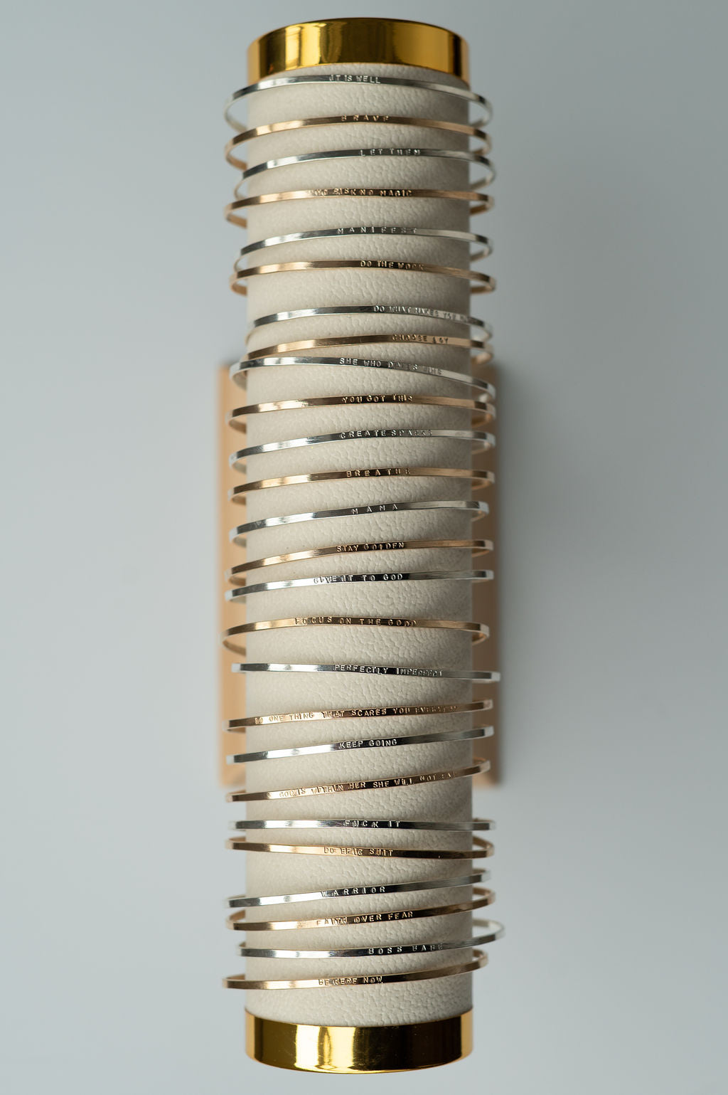 Decorative wall sconce with spiral design and gold accents on a gray background