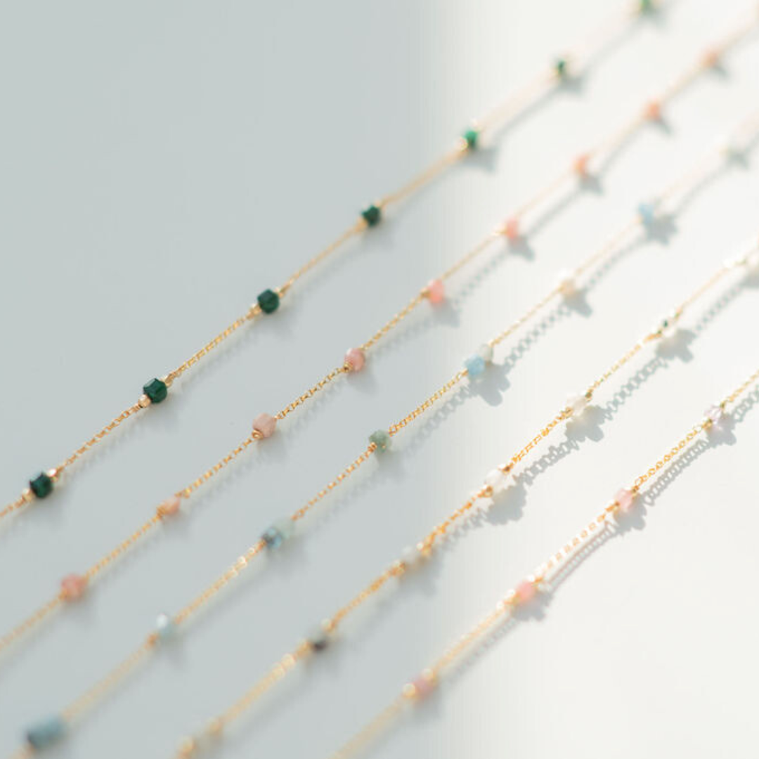 Set of beaded necklaces on a light gray background