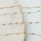 Gold and silver chain necklaces on a marble surface