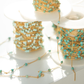 Gold and turquoise beaded chains on a white surface
