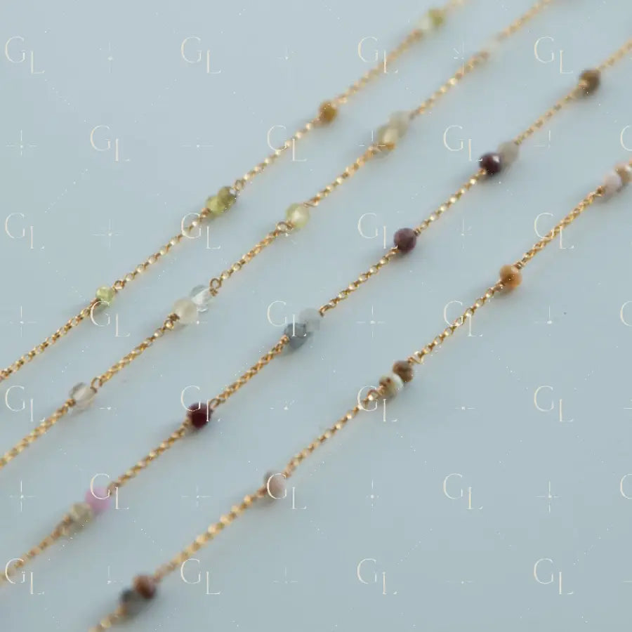 Three gold necklaces with small beads on a light blue background handmade