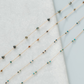 Necklace with small beads on a light gray background