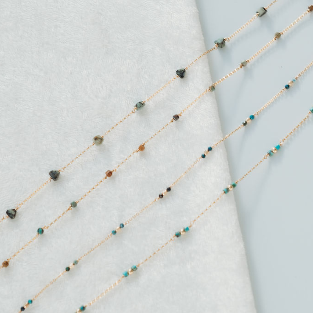 Necklace with small beads on a light gray background