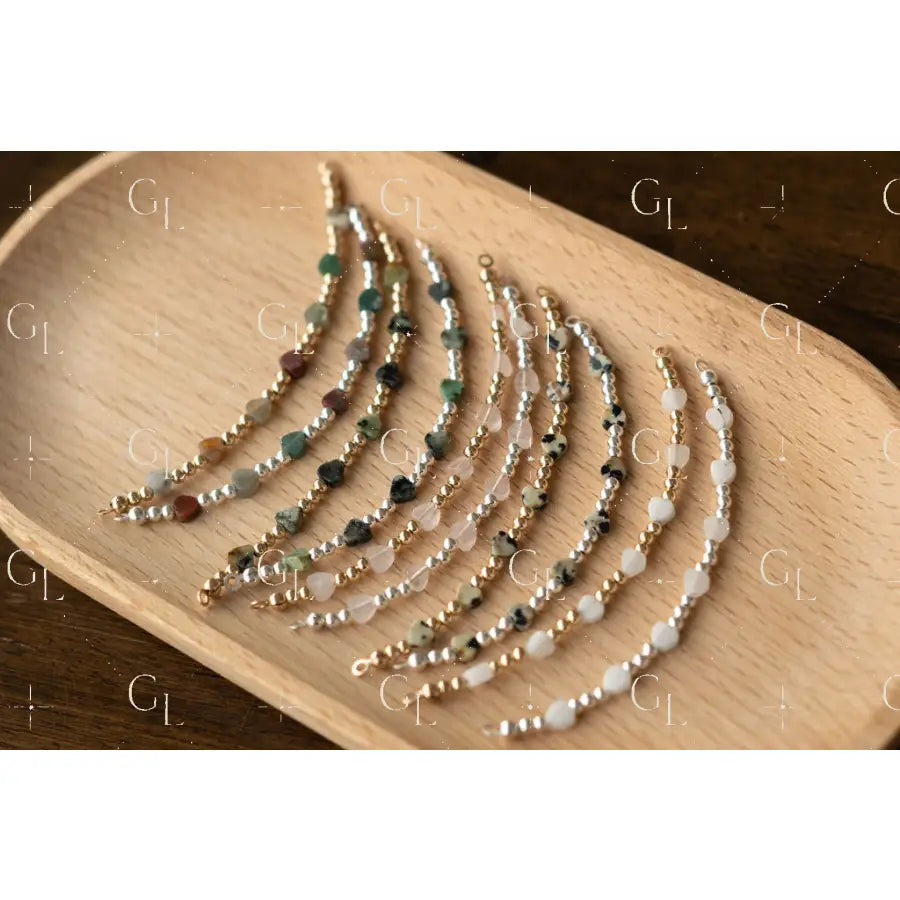 Set of beaded bracelets on a wooden tray