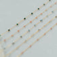 Three beaded necklaces on a light gray background