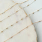 Three gold fill chain of different lengths on a marble surface