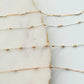 Gold and silver chain necklaces on a marble surface