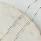 Close-up of gold fill and sterling silver chains on a marble surface