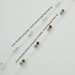 Jewelry necklace with beads labeled on a light gray background