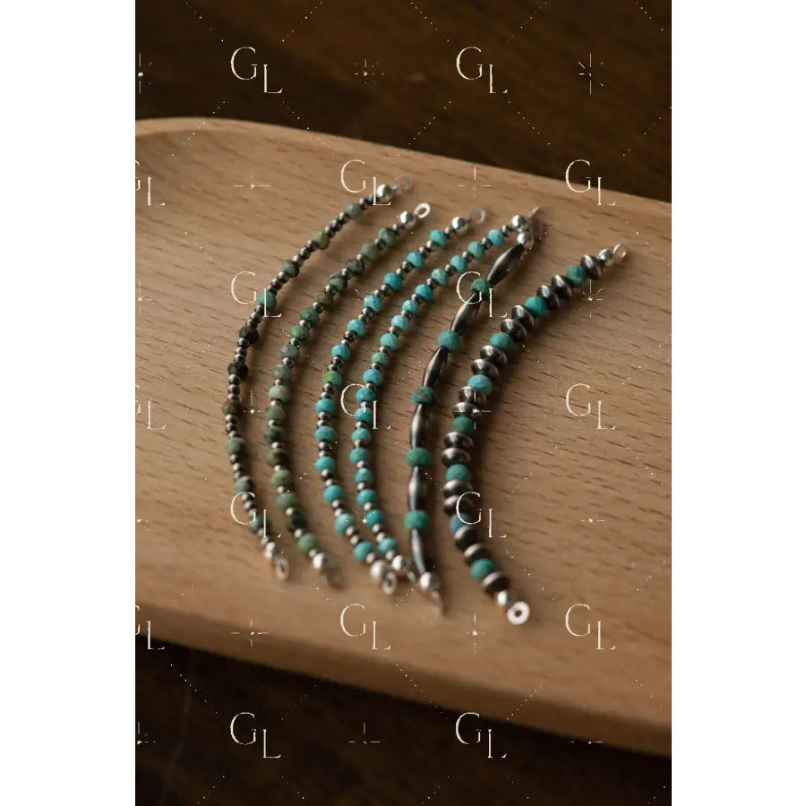 Navajo Pearl + Turquoise Glow Ups on wood surface 