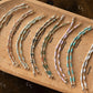 Set of half beaded bracelet on a wooden board with color labels