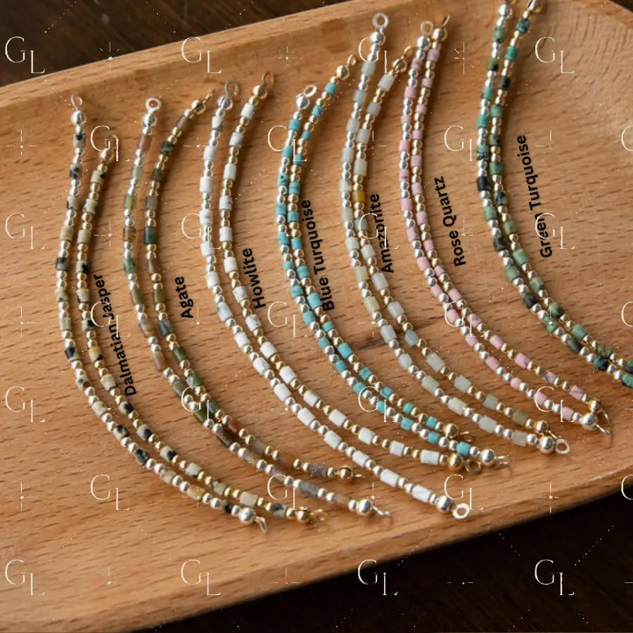 Set of beaded bracelet on a wooden board with labels