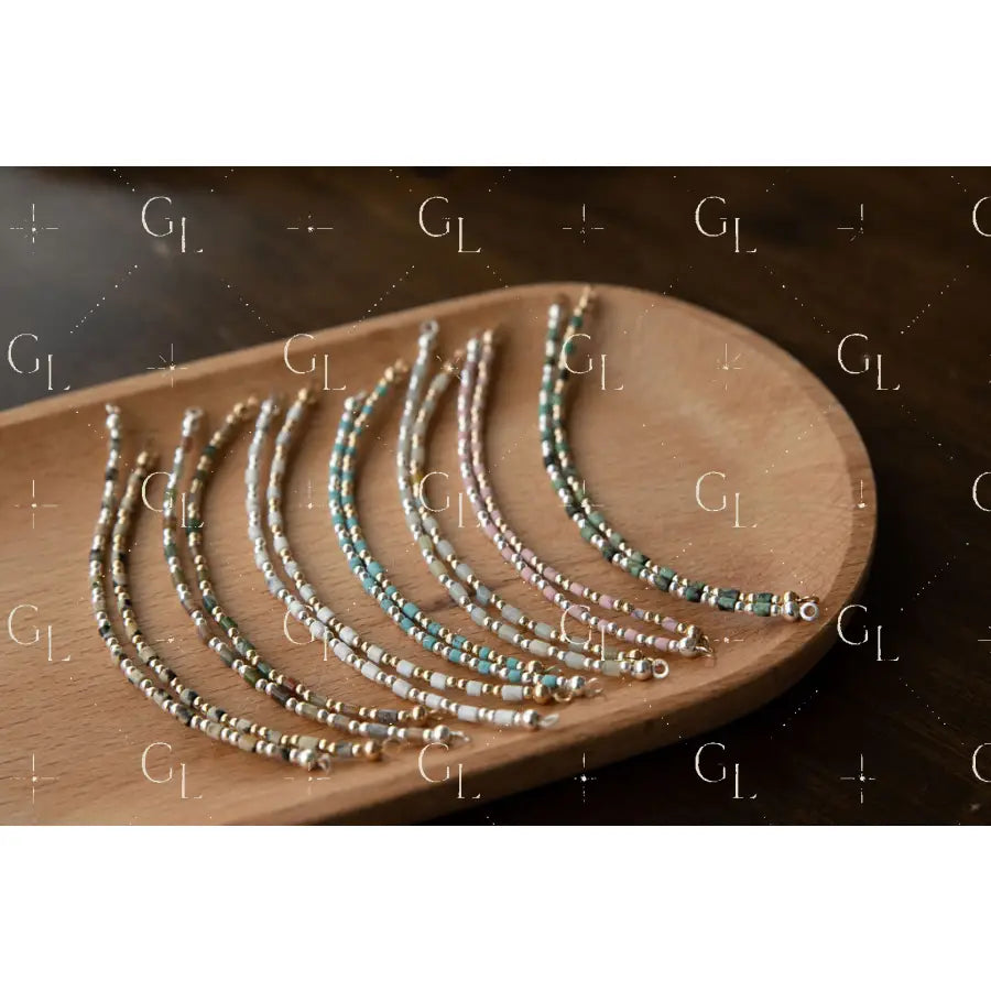 Set of beaded bracelet on a wooden tray