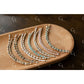 Set of beaded bracelet on a wooden tray
