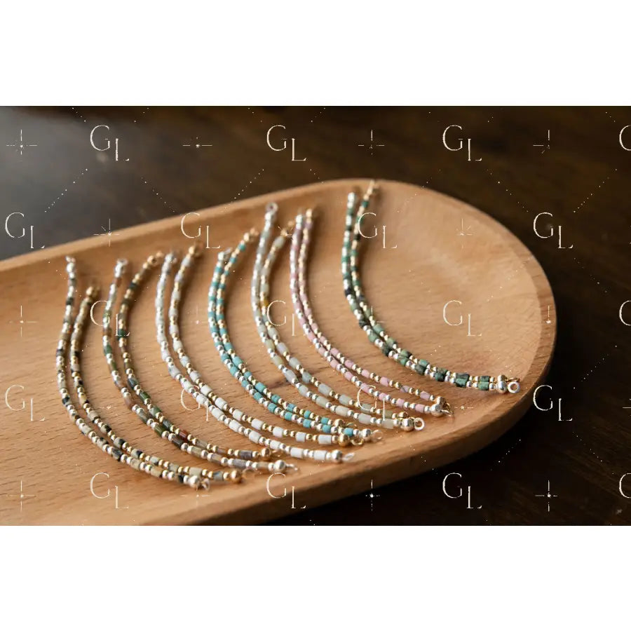 Set of beaded bracelet on a wooden tray